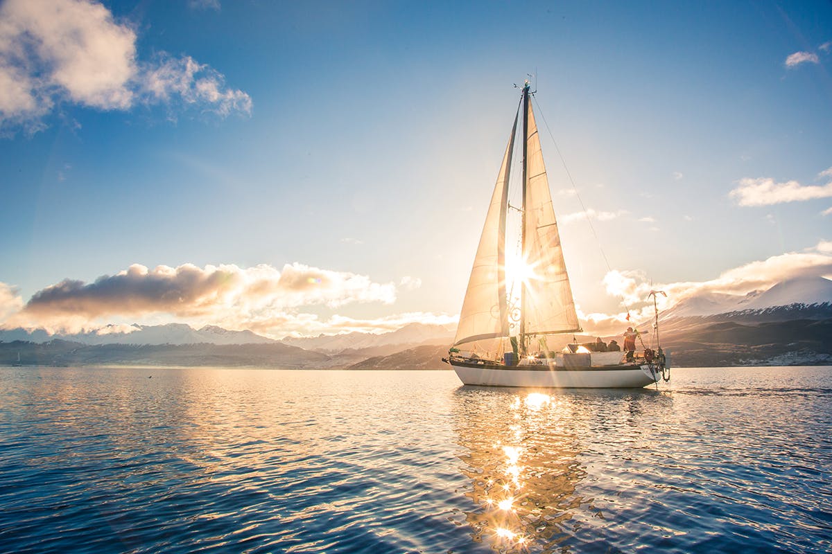 Boat sailing into a beautiful sunset
